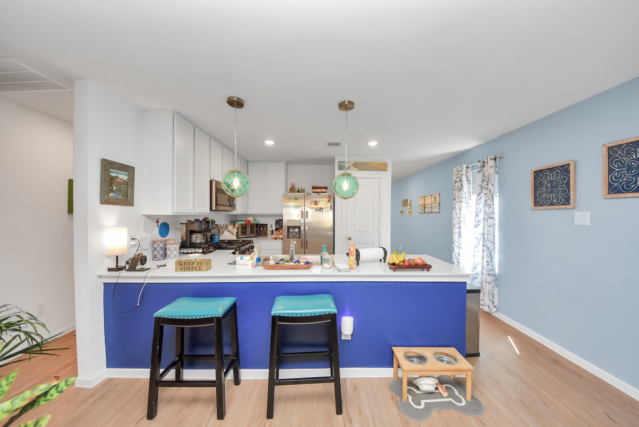 1719 Windrose Bend Angleton, TX 77515 - Photo 10 of 31 a room with stainless steel appliances kitchen island granite countertop a sink a stove a dining table and chairs