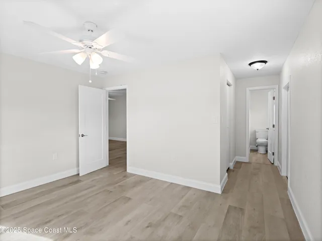 a view of a chandelier fan and entryway