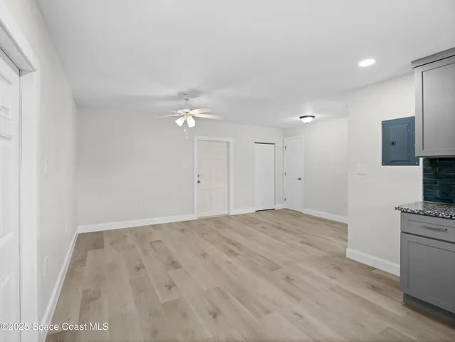 a view of empty room with wooden floor and fireplace