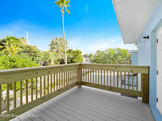 a view of a balcony with wooden floor