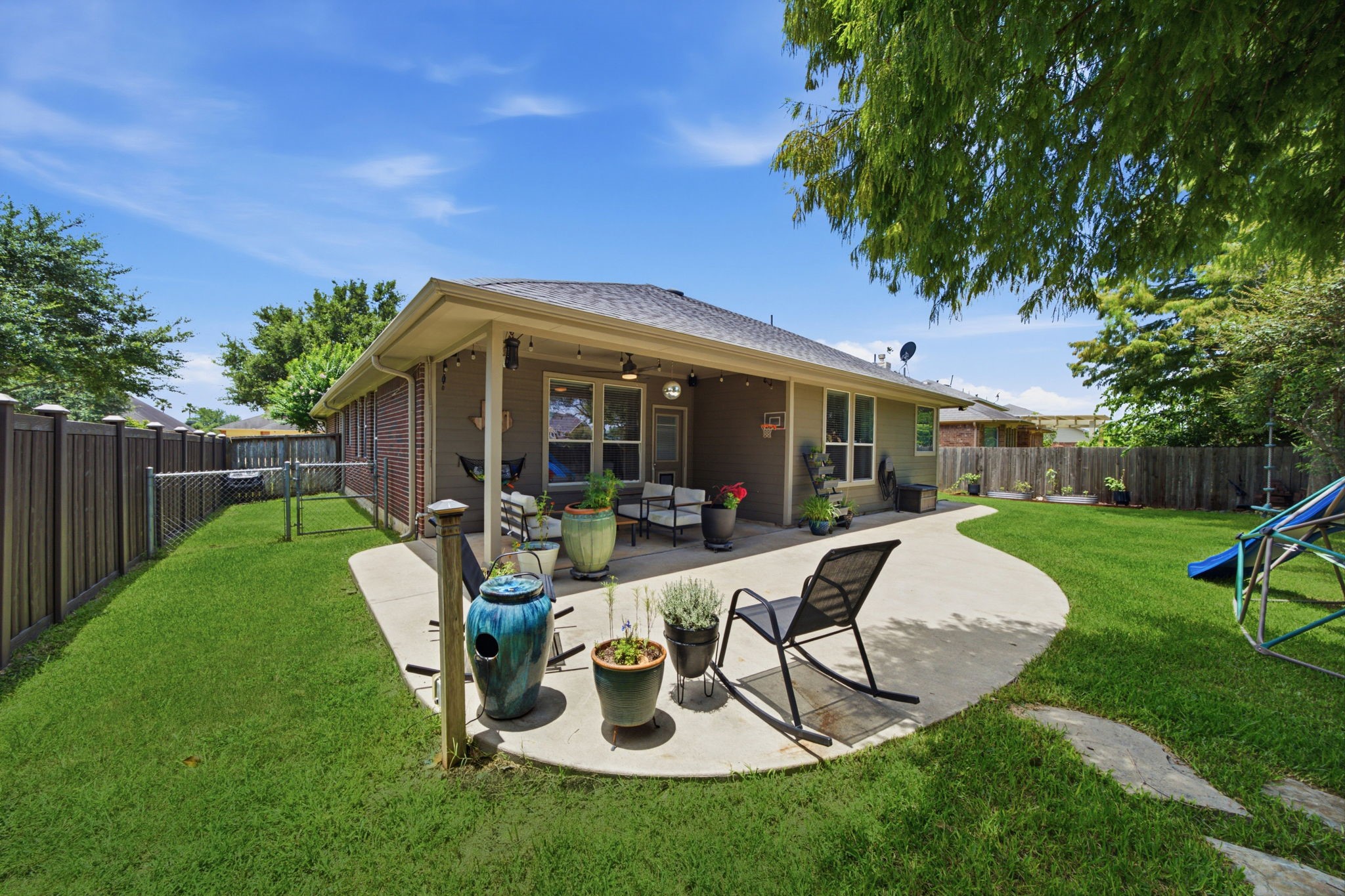8911 Henrico Lane Rosenberg, TX 77469 - Photo 30 of 45 a view of a house with backyard sitting area and garden