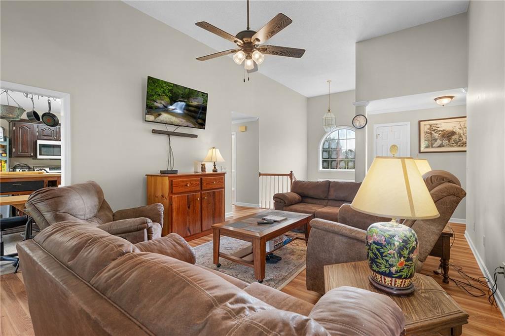 240 Orchard Way Southeast Calhoun, GA 30701 - Photo 4 of 38 a living room with furniture a flat screen tv and a window