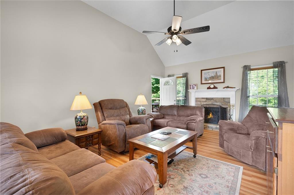 240 Orchard Way Southeast Calhoun, GA 30701 - Photo 5 of 38 a living room with furniture a fireplace and a chandelier