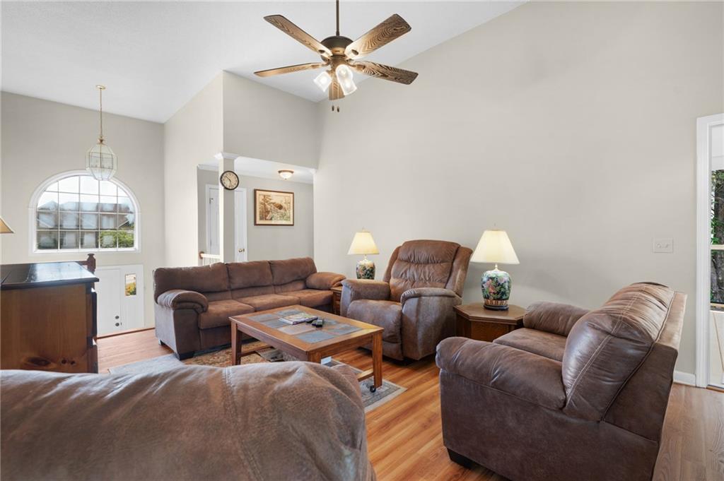 240 Orchard Way Southeast Calhoun, GA 30701 - Photo 7 of 38 a living room with furniture a chandelier and a window