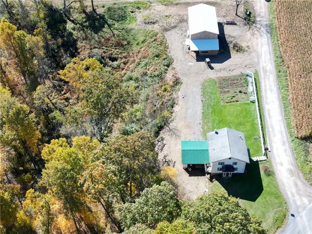 an aerial view of a house with a yard and garden