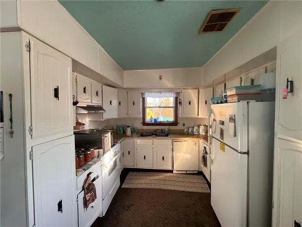 a kitchen with a refrigerator and a sink