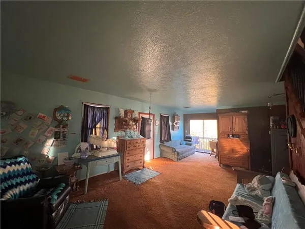 a bedroom with furniture and a flat screen tv