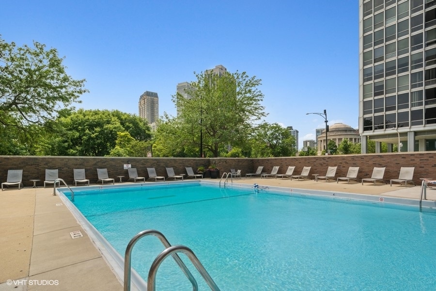 2800 North Lake Shore Drive, Unit 2603 Chicago, IL 60657 - Photo 5 of 7 a view of a swimming pool with outdoor seating and a yard