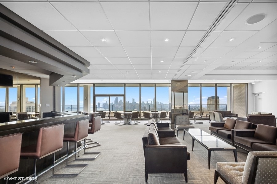 2800 North Lake Shore Drive, Unit 2603 Chicago, IL 60657 - Photo 7 of 7 a large living room with lots of furniture and a large window