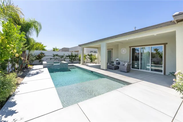 a kitchen with refrigerator and chairs