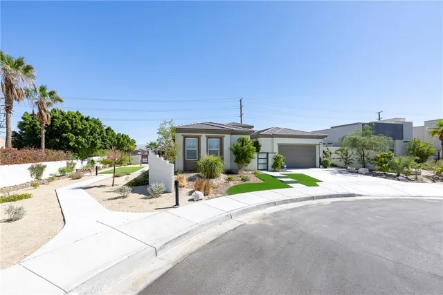 a front view of a house with a yard and a garage