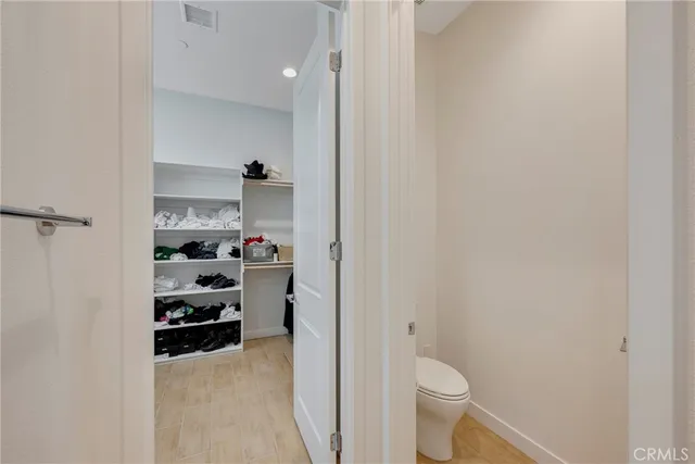 a bedroom with a bed and a chair