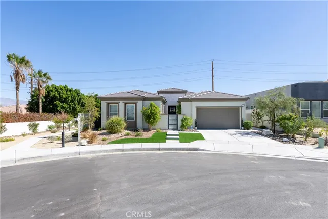 a front view of a house with a garden and patio