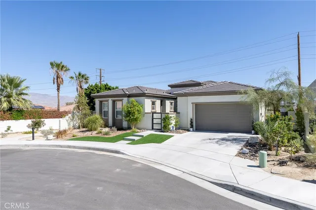 a living room with patio furniture and a potted plants