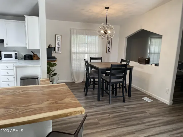 a kitchen with stainless steel appliances kitchen island granite countertop a refrigerator stove and sink