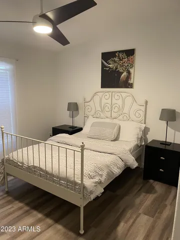 a bedroom with two beds and a desk