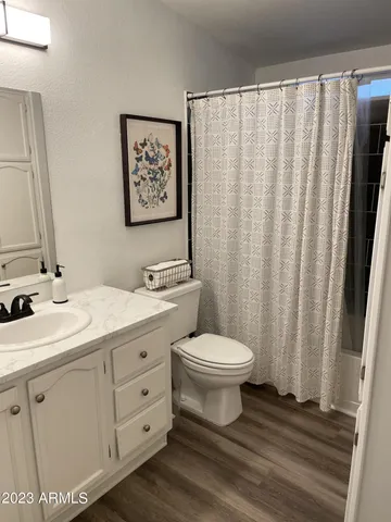 a bedroom with a bed and a night stand