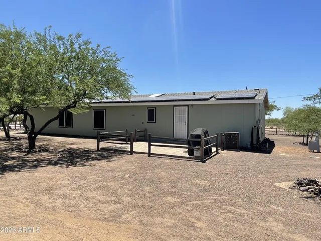 a wooden bench sitting in front of a house