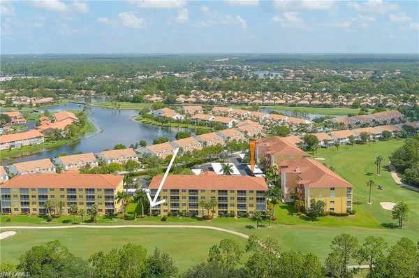 an aerial view of residential houses with outdoor space and lake view