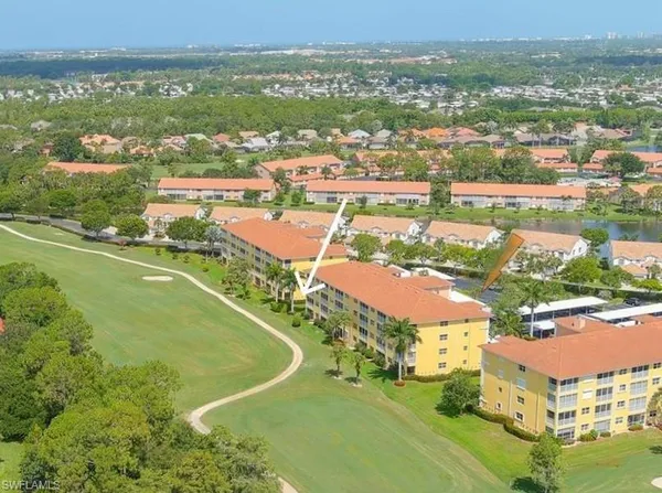 an aerial view of residential houses with outdoor space and river