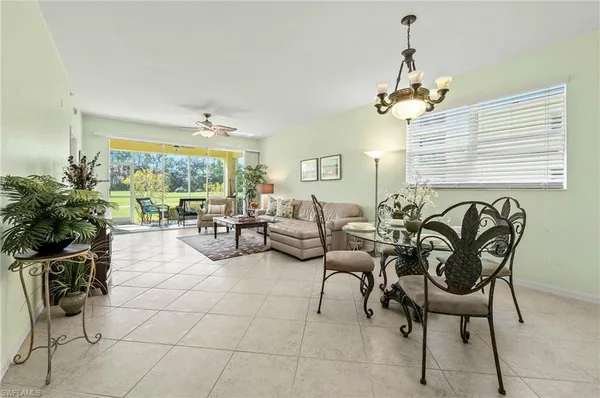 a view of a livingroom with furniture and floor to ceiling window