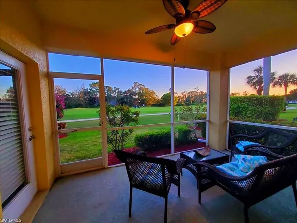 a view of a patio with a table chairs and a backyard