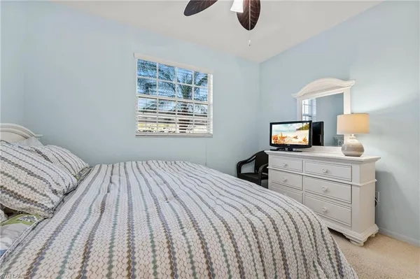 a bedroom with a bed and a television