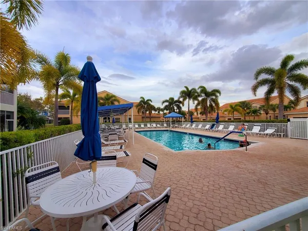 a view of a swimming pool with a patio and a garden