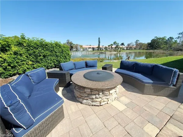a view of a patio with couches chairs and a fire pit