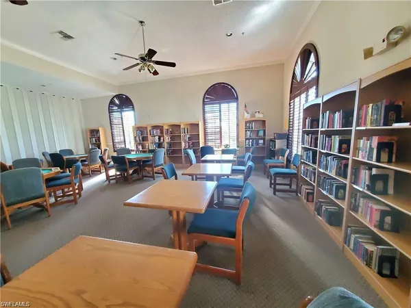 a living room with lots of furniture and a book shelf