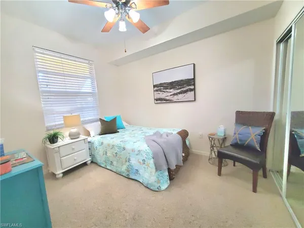 a spacious bedroom with a bed and a chandelier
