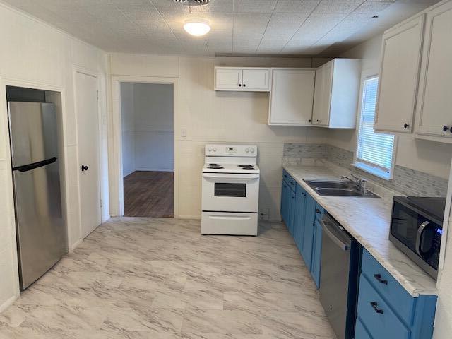 2617 39th Street Lubbock, TX 79413 - Photo 5 of 12 a kitchen with a stove top oven and refrigerator