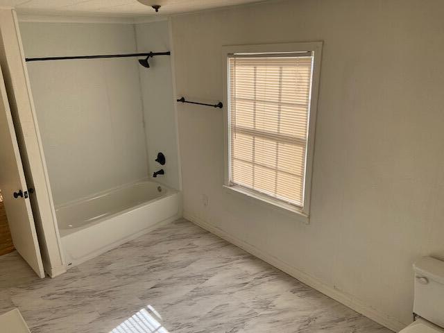 2617 39th Street Lubbock, TX 79413 - Photo 8 of 12 a bathroom with a bathtub and a shower