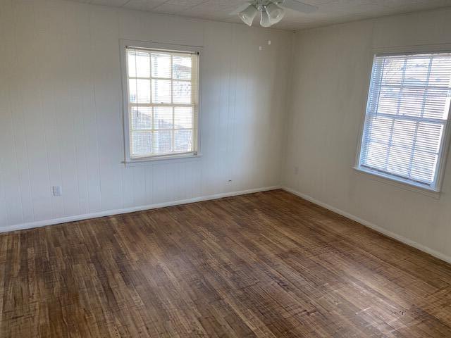 2617 39th Street Lubbock, TX 79413 - Photo 10 of 12 an empty room with wooden floor cabinet and windows