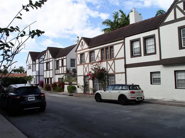 a view of a cars park in front of a building