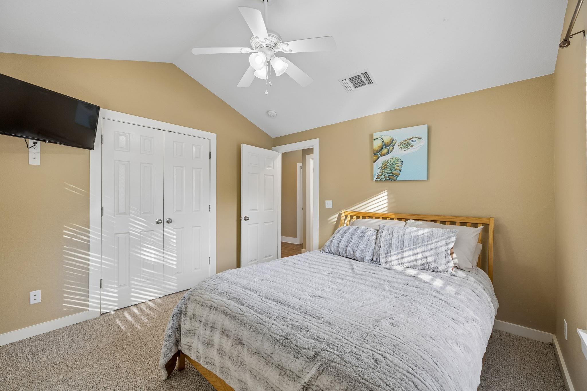 230 Lee Street Seguin, TX 78155 - Photo 27 of 40 a bedroom with a large bed and a chandelier