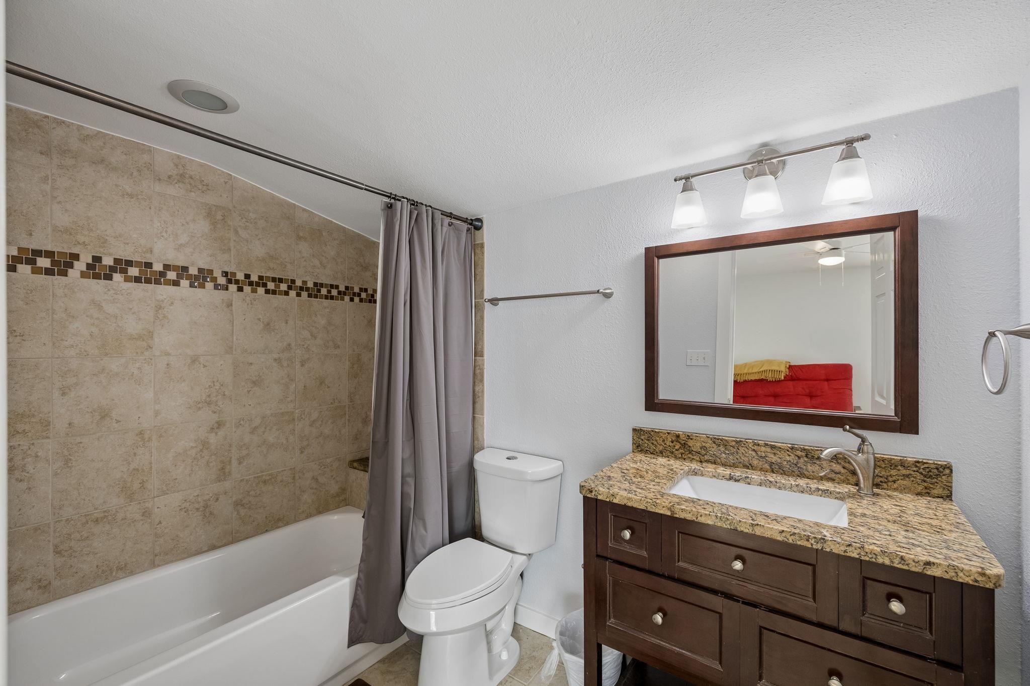 230 Lee Street Seguin, TX 78155 - Photo 34 of 40 a bathroom with a granite countertop sink toilet and shower