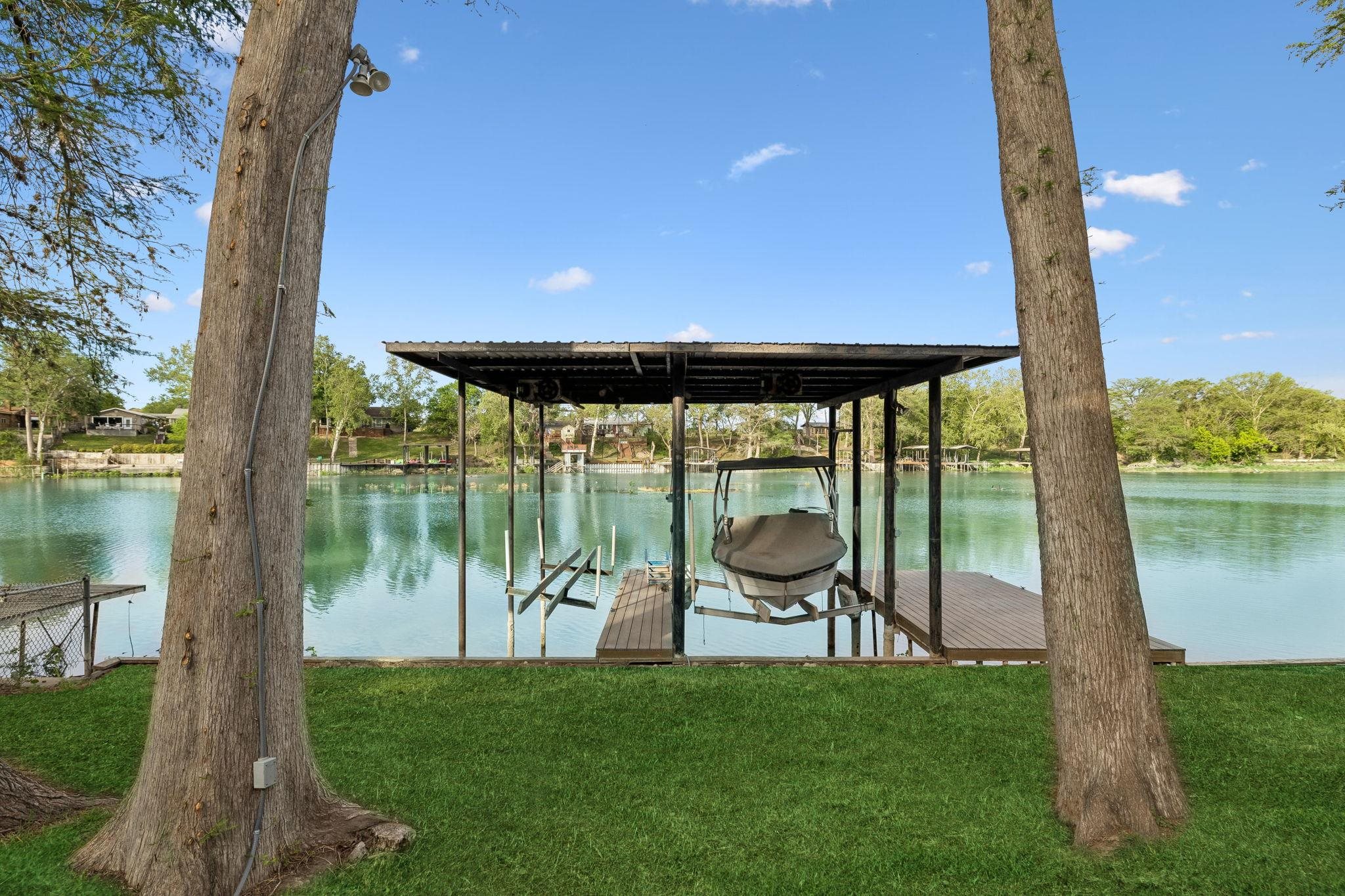 230 Lee Street Seguin, TX 78155 - Photo 5 of 40 a backyard of a house with table and chairs under an umbrella