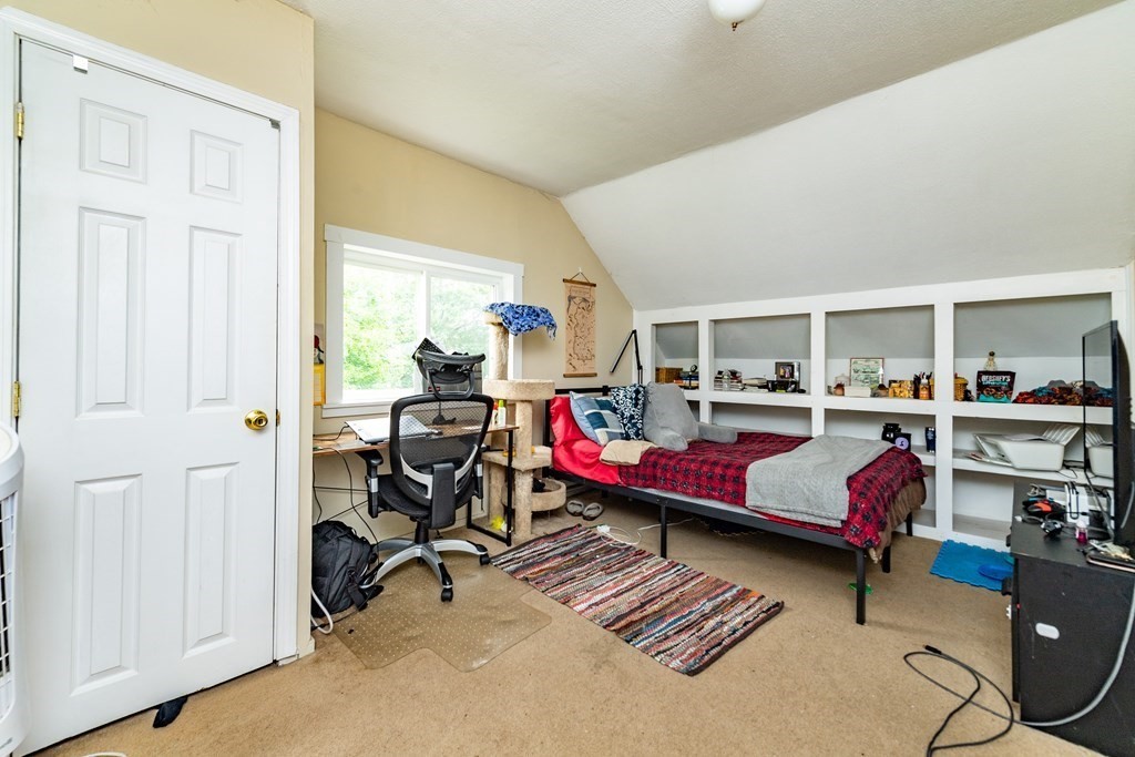 28 Walnut Street Natick, MA 01760 - Photo 16 of 24 a living room with furniture gym equipment and a table