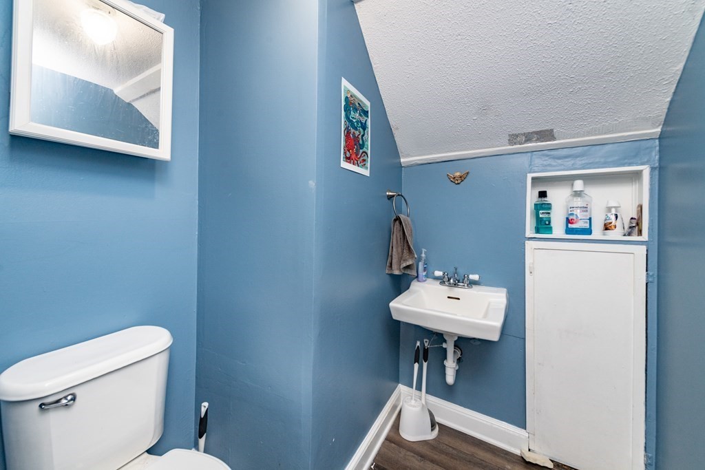 28 Walnut Street Natick, MA 01760 - Photo 18 of 24 a bathroom with a toilet a sink and mirror