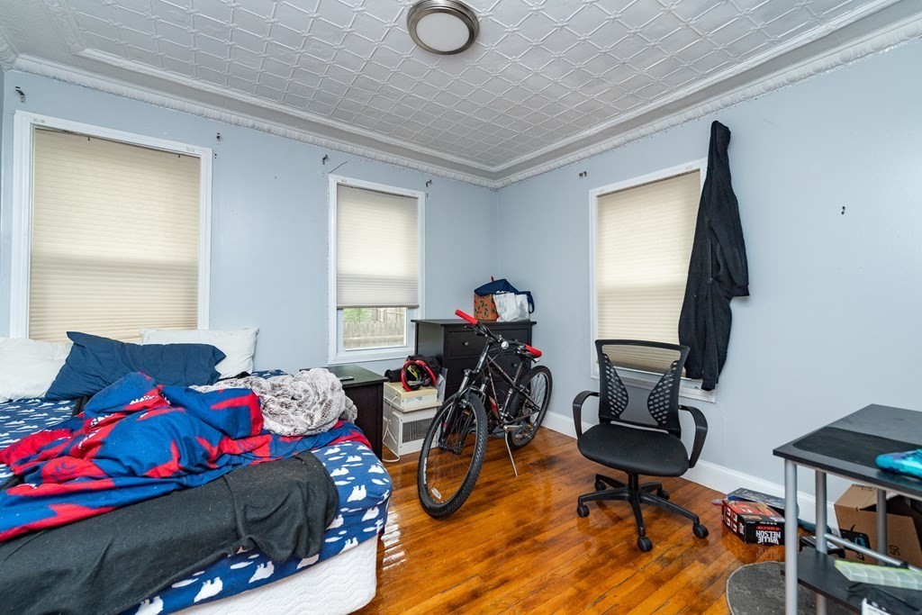 28 Walnut Street Natick, MA 01760 - Photo 19 of 24 a bedroom with a bed and wooden floor