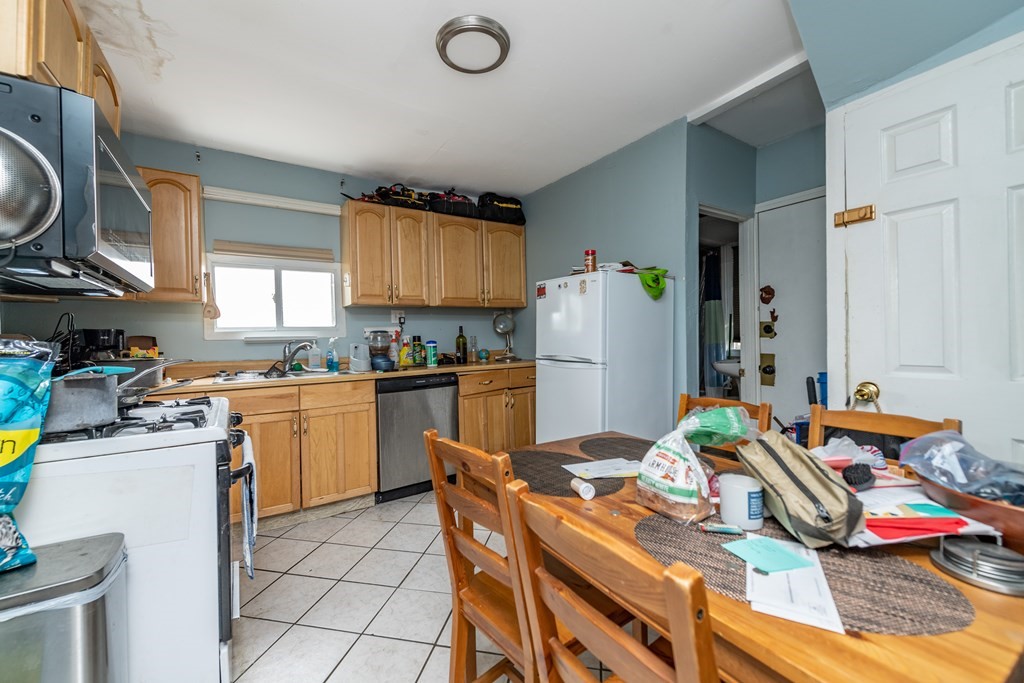 28 Walnut Street Natick, MA 01760 - Photo 20 of 24 a kitchen with stainless steel appliances granite countertop a refrigerator and a stove top oven