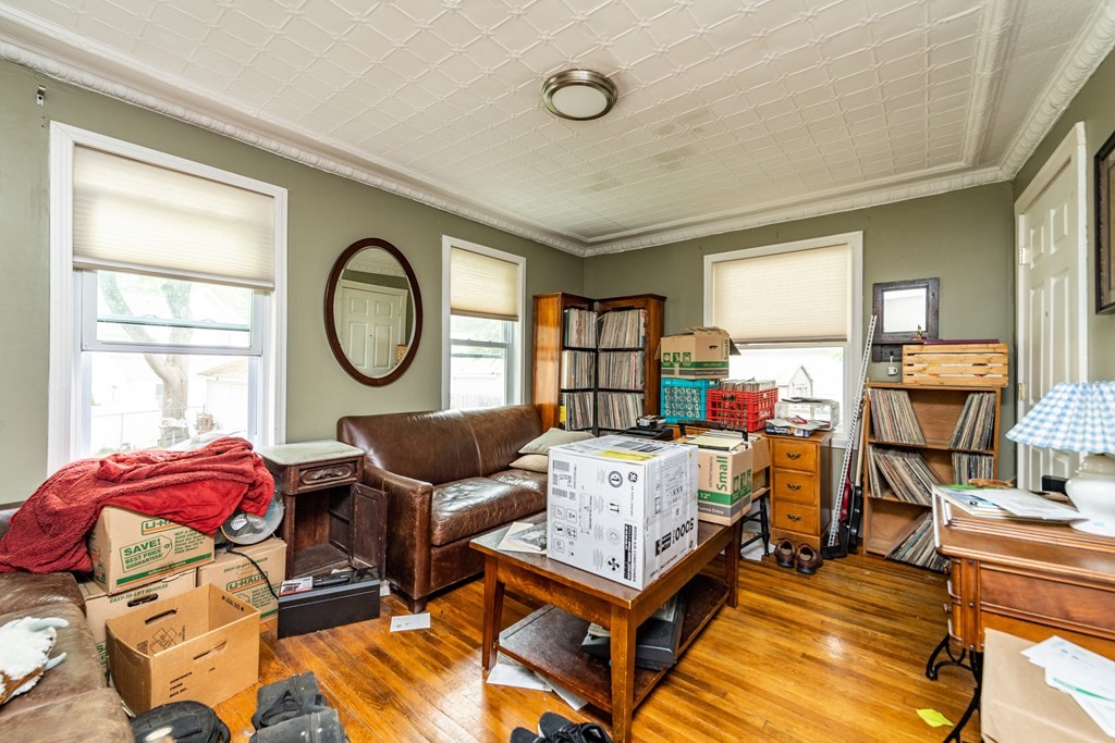28 Walnut Street Natick, MA 01760 - Photo 22 of 24 a living room with furniture a fireplace and a large window