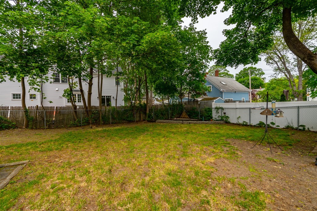 28 Walnut Street Natick, MA 01760 - Photo 6 of 24 a view of backyard of house with green space