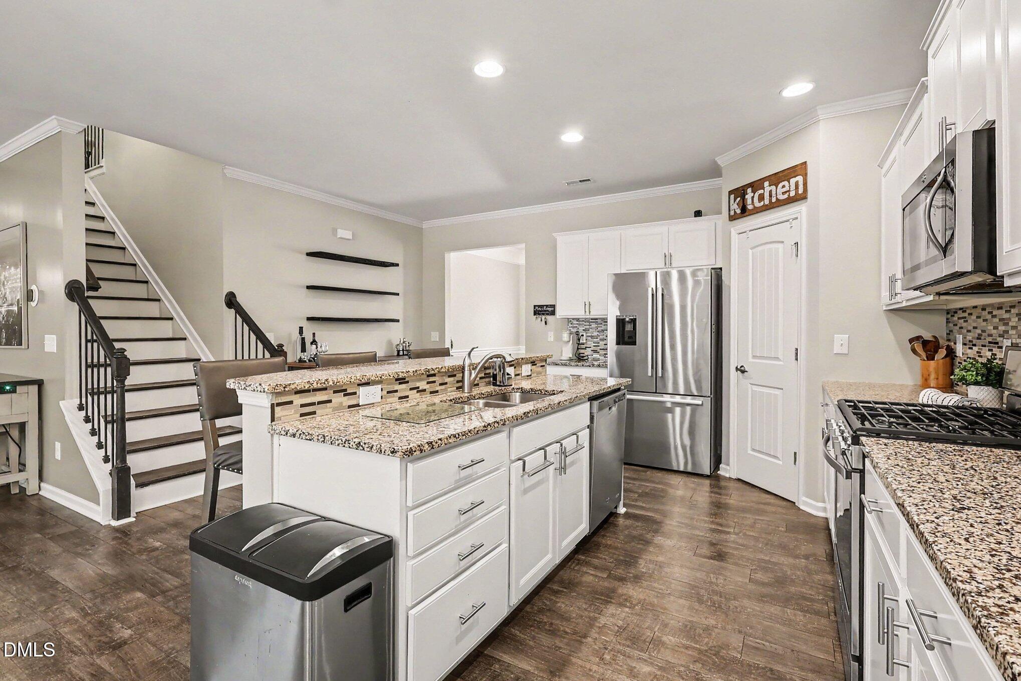 4366 Auburn Hills Drive Raleigh, NC 27616 - Photo 12 of 40 a kitchen with stainless steel appliances granite countertop a stove oven and refrigerator