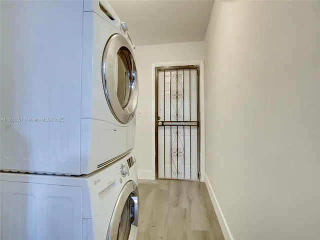 a kitchen with stainless steel appliances a refrigerator a stove a dining table and chairs