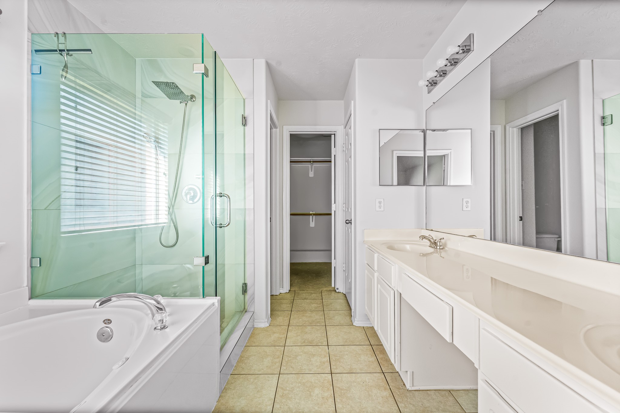 16210 Bloom Meadow Trail Cypress, TX 77433 - Photo 14 of 32 a bathroom with a tub sink and mirror