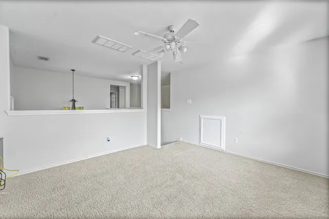 a view of a kitchen with a sink and a ceiling fan