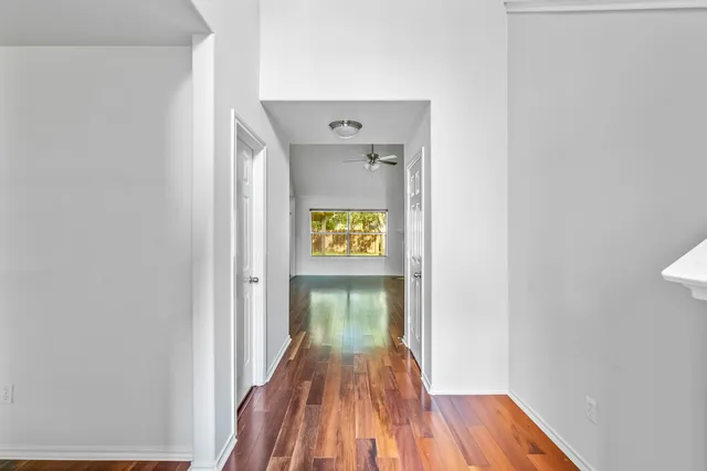 a view of a hallway with wooden floor