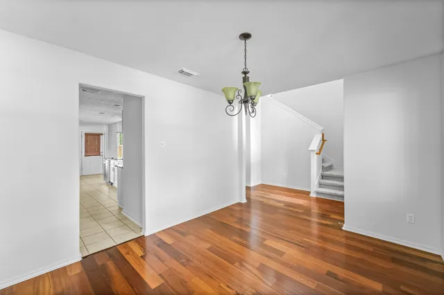 a view of an empty room and wooden floor